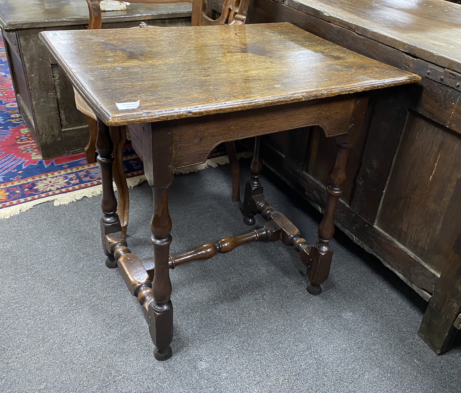 A late 17th century William and Mary small rectangular oak centre table, with arched apron, on square and baluster turned legs, joined by H-stretcher, width 72cm, depth 53cm, height 69cm